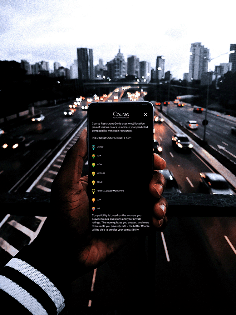 Hand holding a phone over a freeway open to Course Home Info Screen